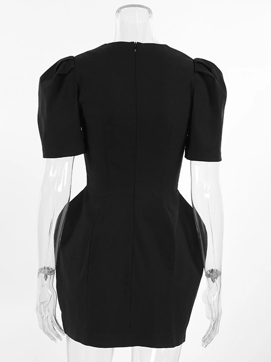 Black dress on a mannequin with a clear stand against a white background