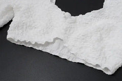 Close-up of a textured white fabric on a black background