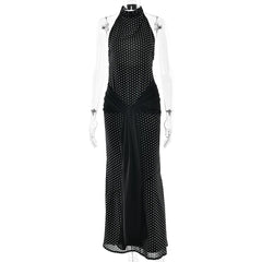 Black polka dot dress on a mannequin against a white background