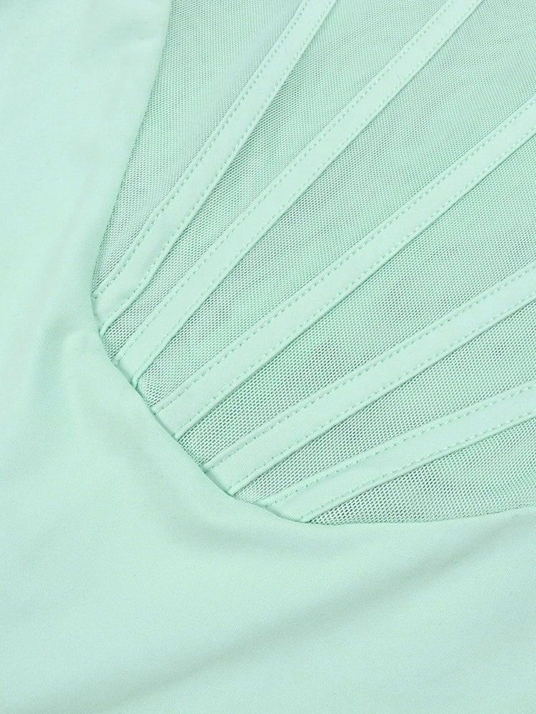 Close-up of a light green fabric with mesh detailing