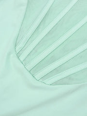 Close-up of a light green fabric with mesh detailing