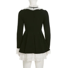 Black dress with white ruffled collar and hem on a mannequin against a white background
