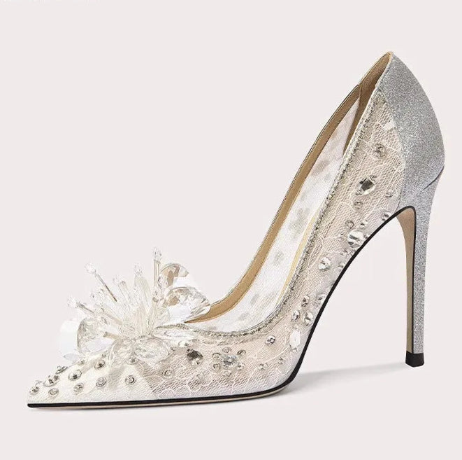 Silver high-heeled shoe with floral design on a white background