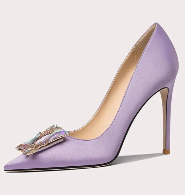 Purple high-heeled shoe with decorative bow on a light gray background