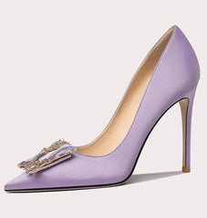 Purple high-heeled shoe with decorative bow on a light gray background