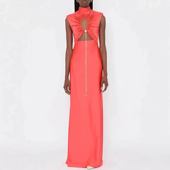 Coral evening gown with cut-out design on a white background