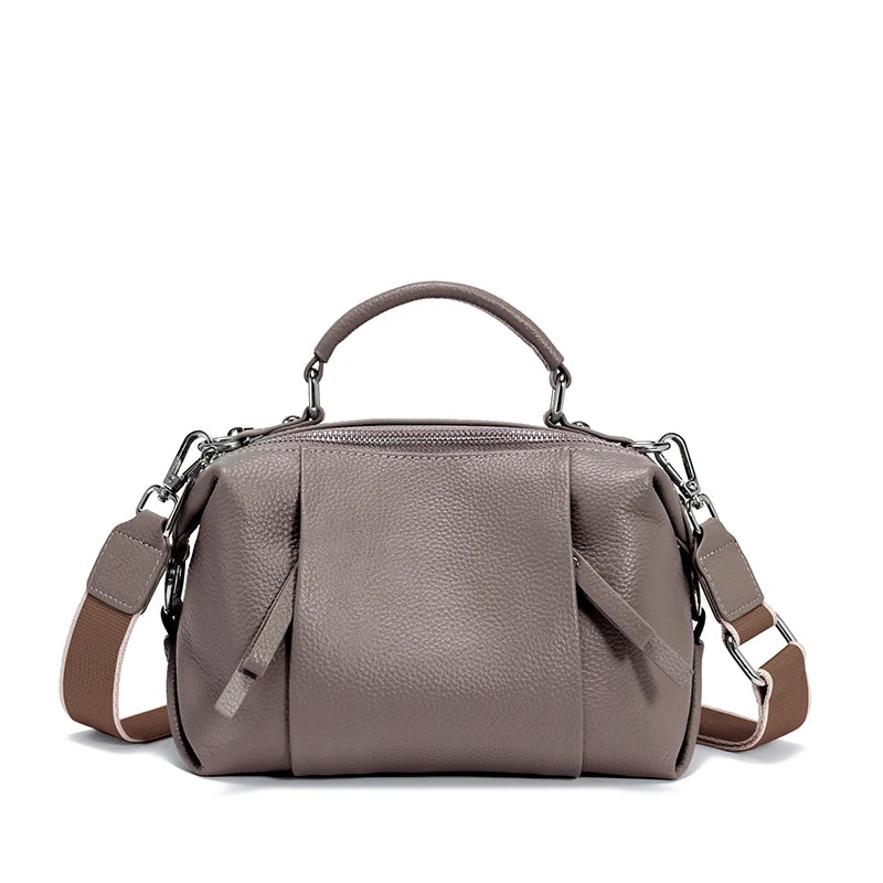 Gray handbag with a shoulder strap on a white background