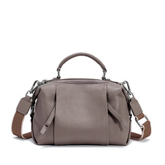 Gray handbag with a shoulder strap on a white background