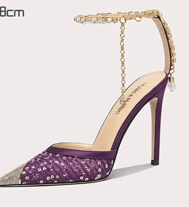 Purple high-heeled shoe with gold accents on a white background