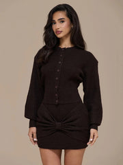 Woman wearing a brown ribbed knit outfit with a bow detail on a beige background