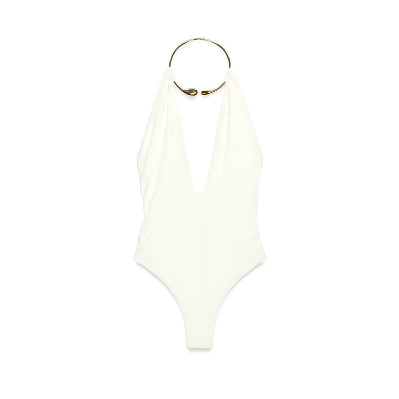 White swimsuit with a gold ring on a white background