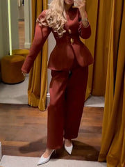 Person wearing a red suit with a peplum top in a room with yellow curtains.