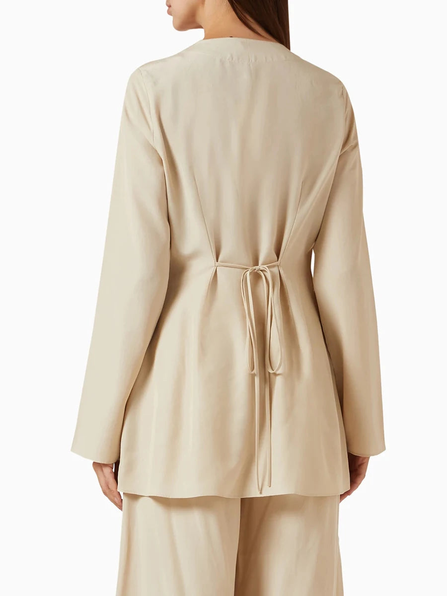 Beige outfit with a jacket and pants on a white background