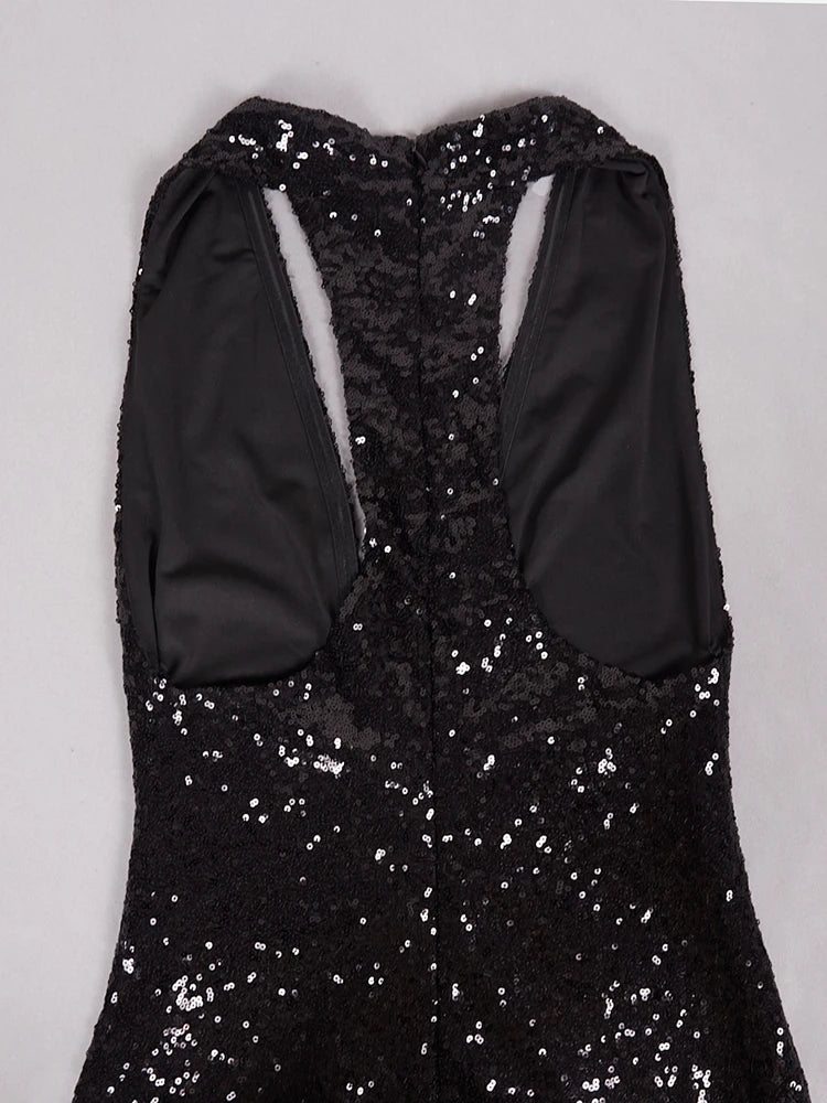 Black sequin dress with long sleeves on a light gray background