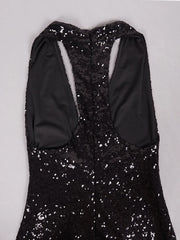 Black sequin dress with long sleeves on a light gray background