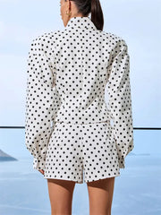 Person wearing a polka dot outfit with a blurred background