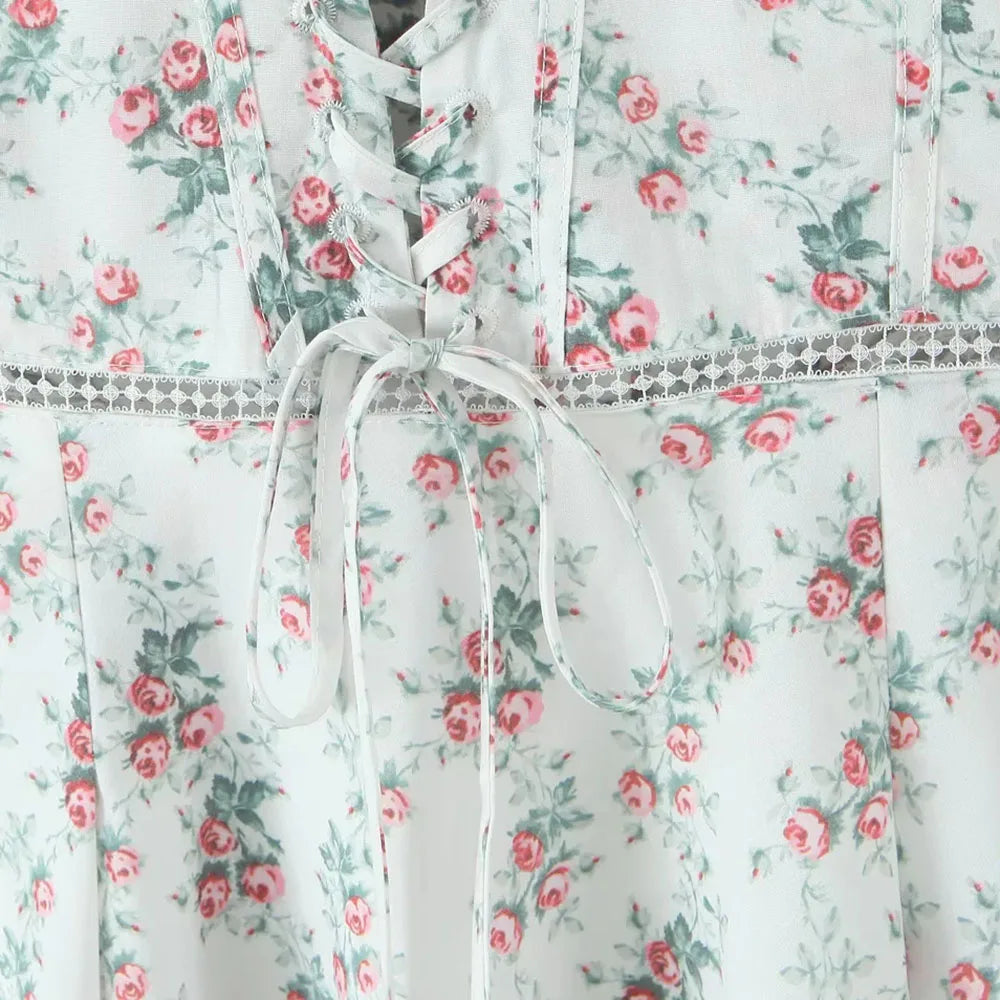 Floral dress with pink roses and green leaves on a white background