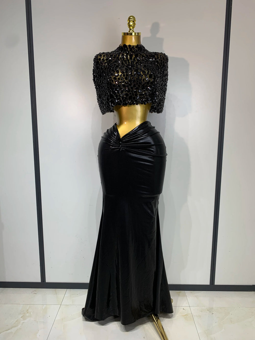 Black embellished mock neck sleeveless top and draped faux leather maxi skirt set