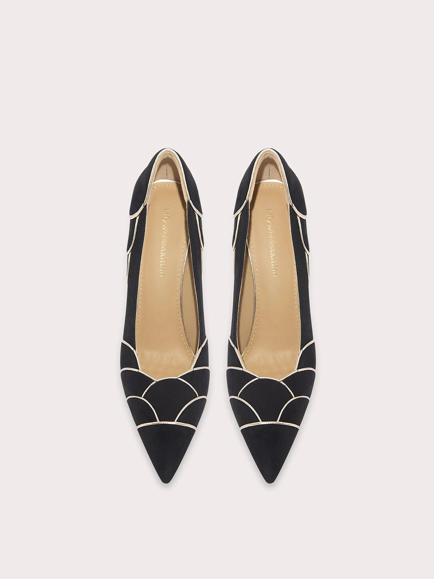Black pointed-toe shoes with geometric design on a white background