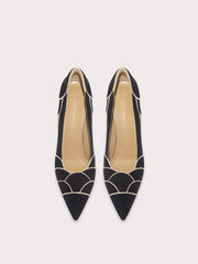 Black pointed-toe shoes with geometric design on a white background