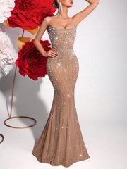 Woman in a sparkly evening gown with red flowers in the background