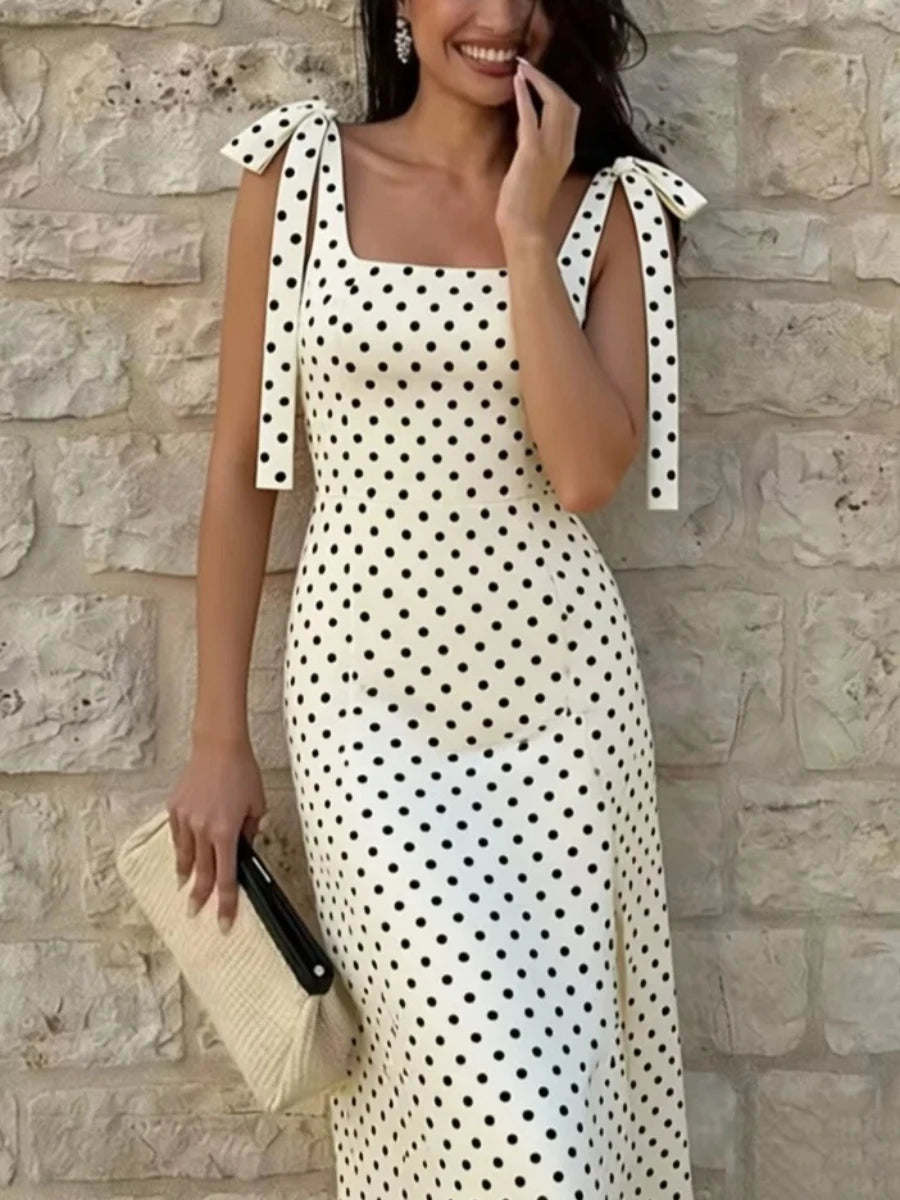 Close-up of a square neck polka dot midi dress with tie shoulder straps