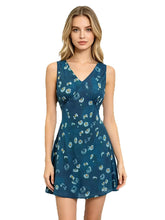 Sleeveless V-neck A-line mini dress with a blue background and white daisy print, worn by a model.