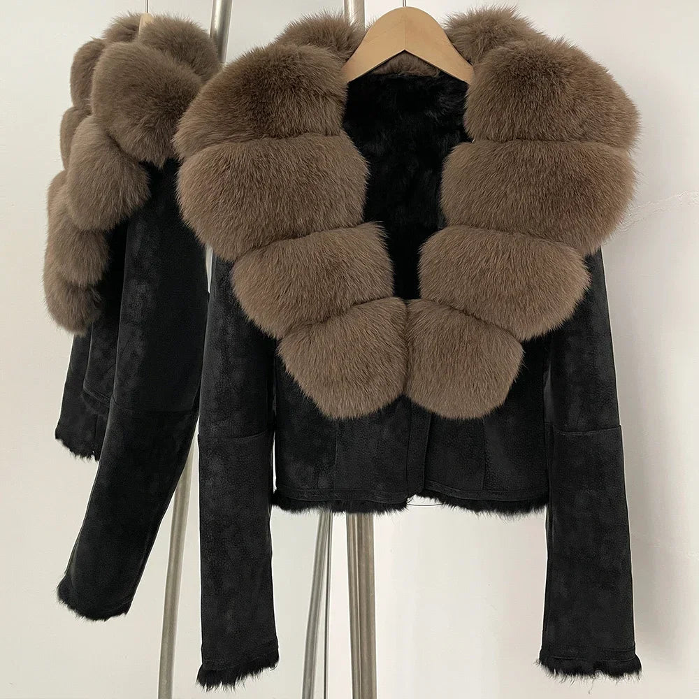 Black suede jacket with brown fur patches on a hanger against a white background