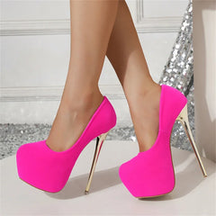 Hot pink high-heeled shoes worn by a person on a neutral background