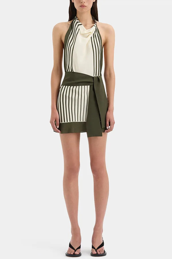 Full body view of a stripe halter neck mini dress