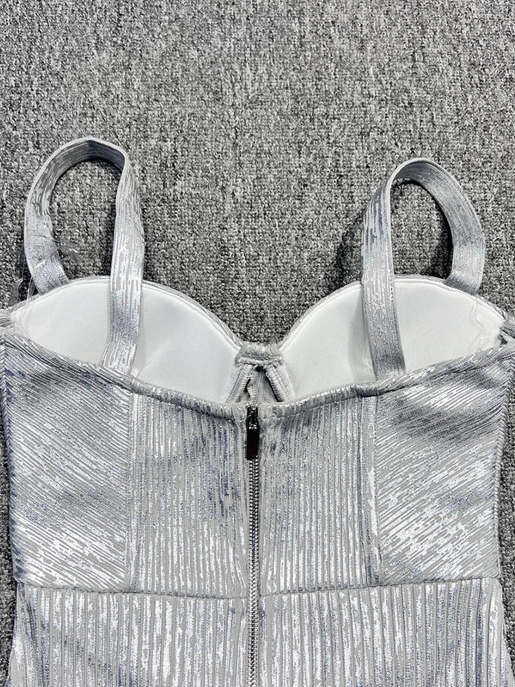 Silver metallic evening gown with a textured pattern on a textured gray background