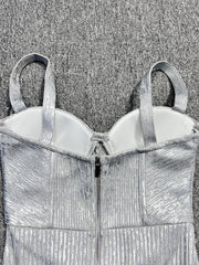 Silver metallic evening gown with a textured pattern on a textured gray background