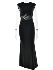 Black evening gown with floral embellishments on a white background