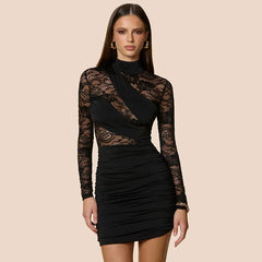 Black lace dress worn by a model on a beige background