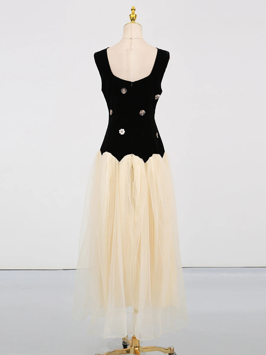 Black bodice with floral details and beige skirt on a mannequin against a white background