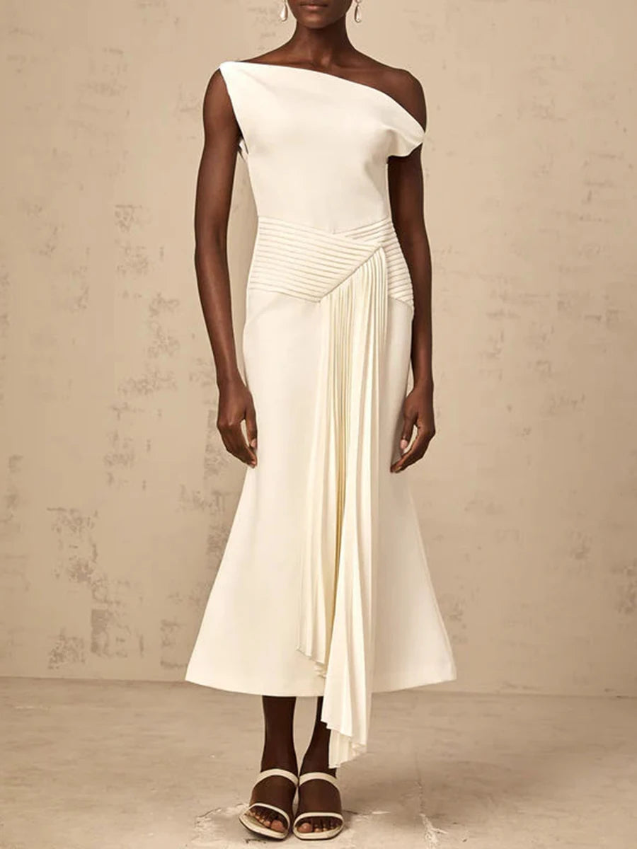 Woman wearing a white one-shoulder dress against a beige background