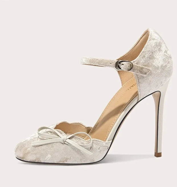 High-heeled shoe with a bow on a white background