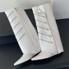 White knee-high boots with zippers on a black surface
