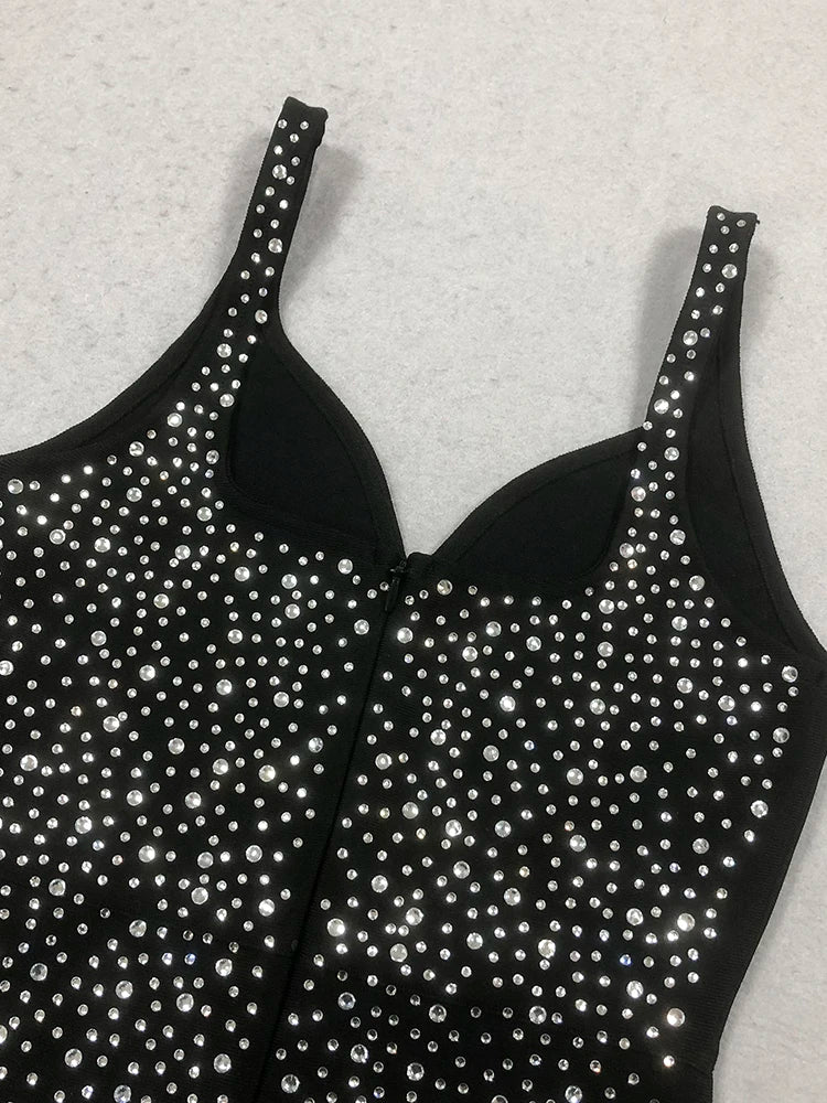 Black tank top with silver rhinestone embellishments on a light gray background