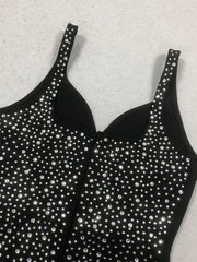 Black tank top with silver rhinestone embellishments on a light gray background