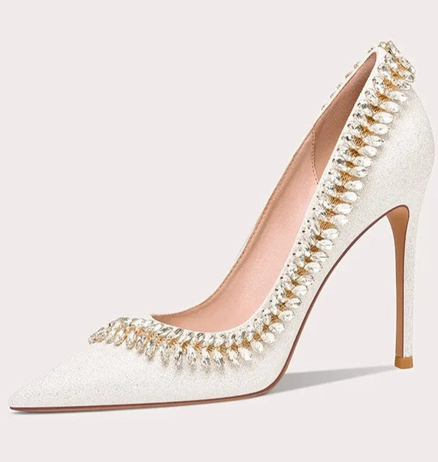 White high-heeled shoe with decorative elements on a white background