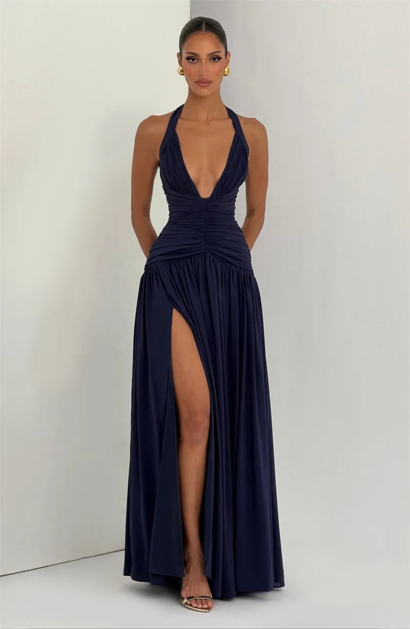 Navy blue evening gown with a plunging neckline and high slit on a white background