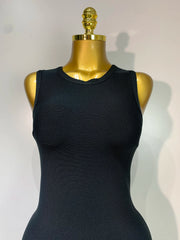 Black sleeveless top on a gold mannequin against a white background