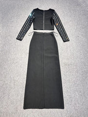 Black outfit with long sleeves and a high-waisted skirt on a gray background