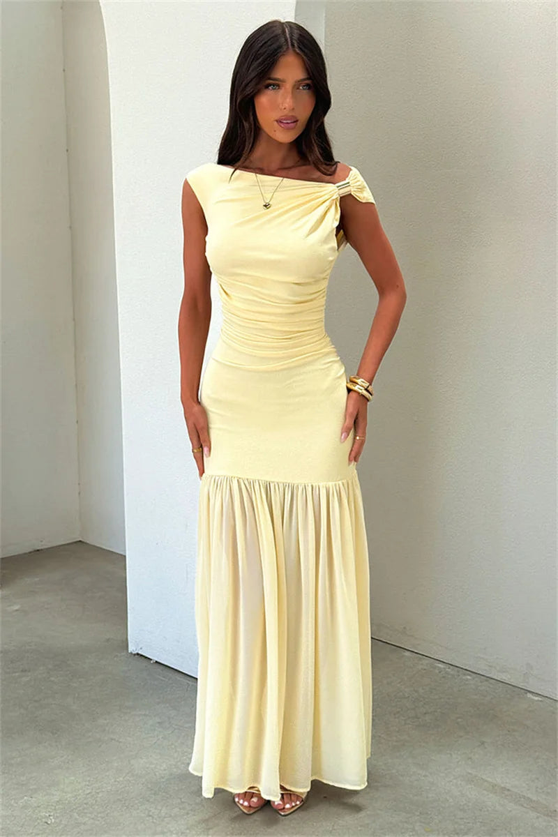 Woman wearing a light yellow dress against a plain background