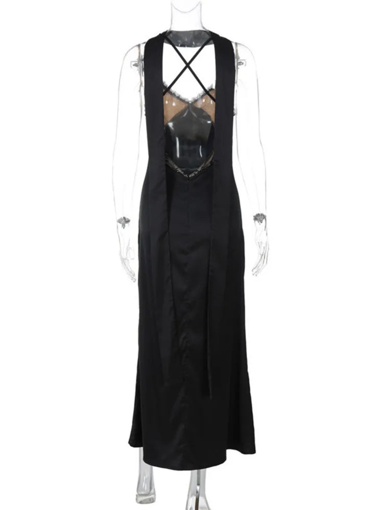 Black sleeveless dress with criss-cross straps on a mannequin against a white background
