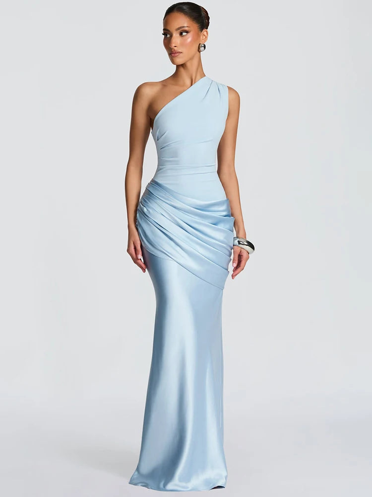 Woman wearing a light blue one-shoulder gown on a white background