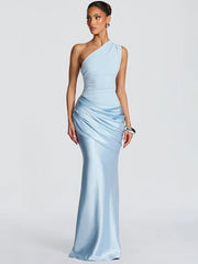 Woman wearing a light blue one-shoulder gown on a white background