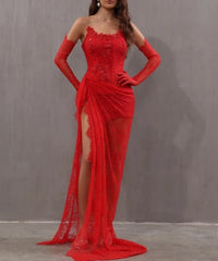 Red evening gown with lace details and a high slit on a plain background