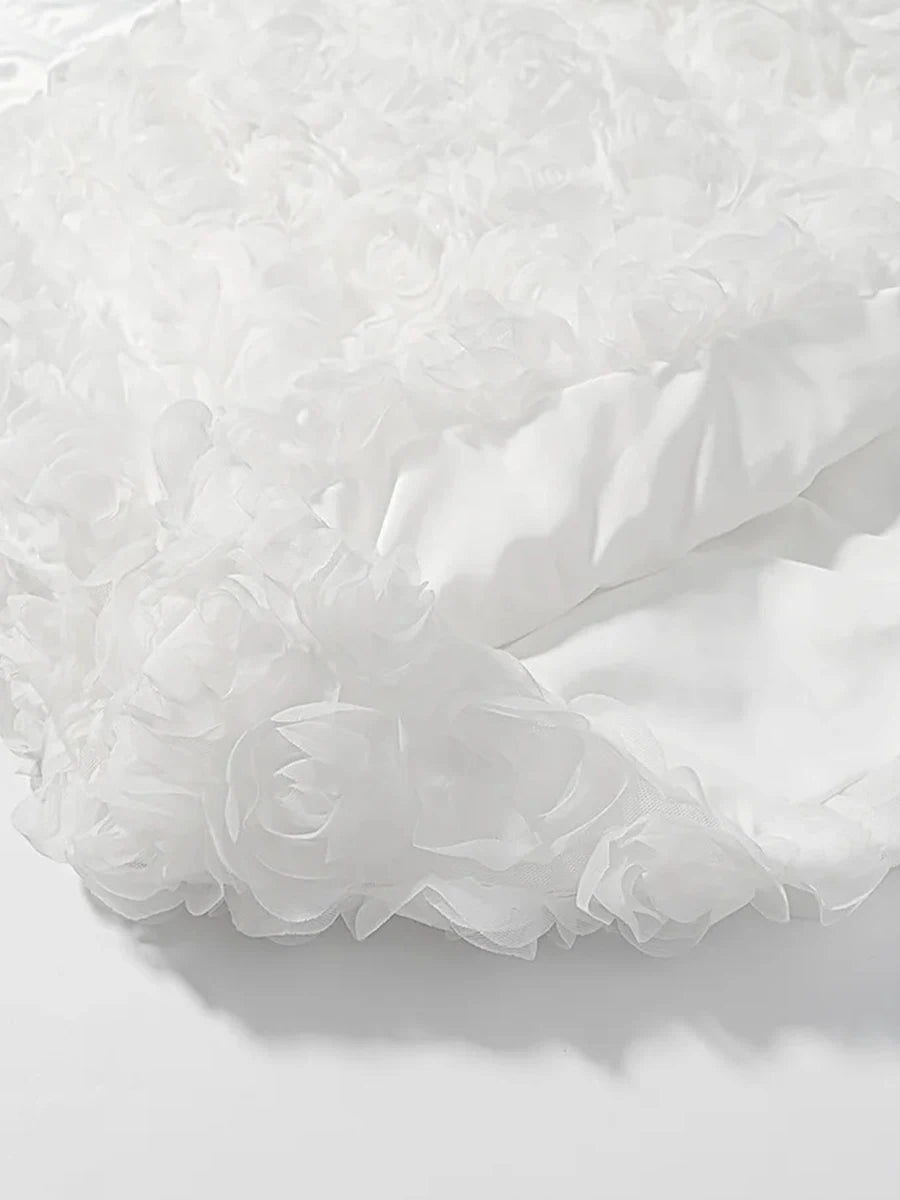 Close-up of white tulle fabric on a light gray background